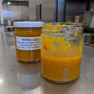 jar of orange coloured hot sauce