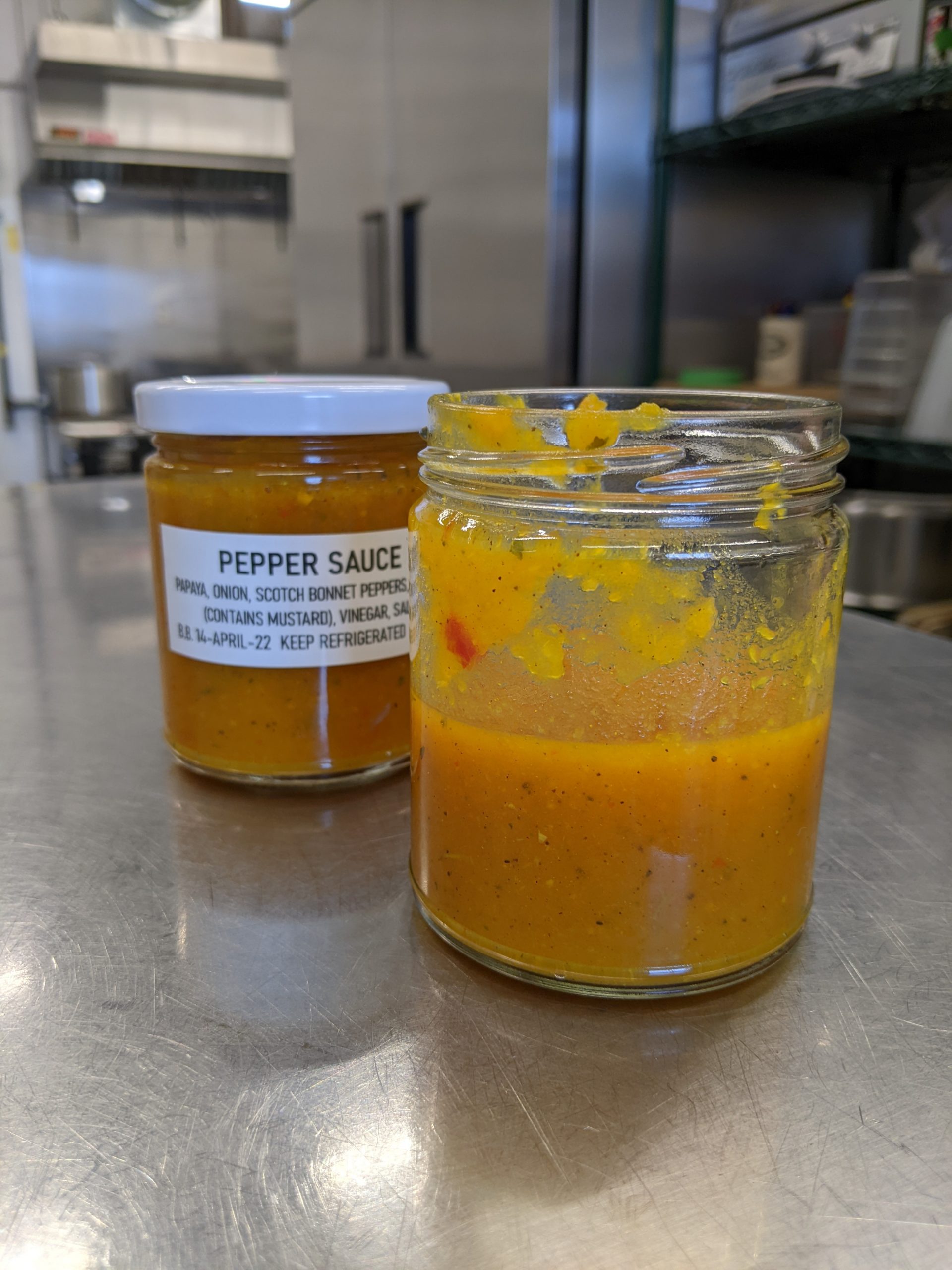 jar of orange coloured hot sauce